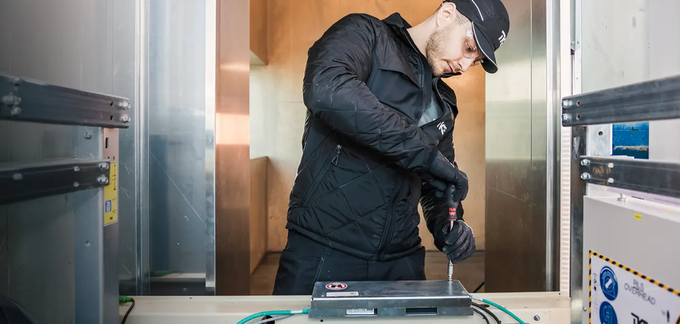 Technician working inside the elevator shaft