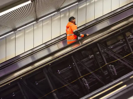  Technician riding a replacement escalator 