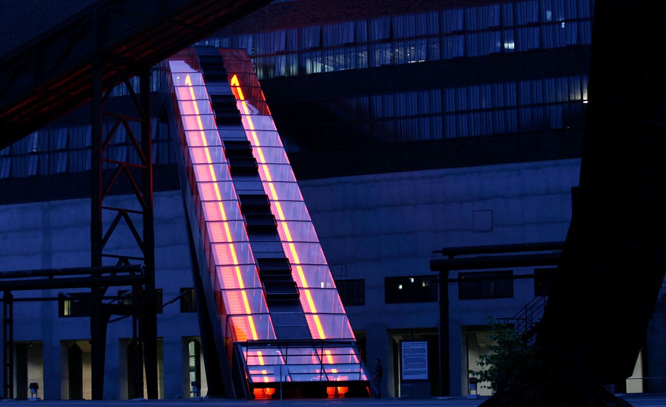  A lighted exterior escalator at night. 