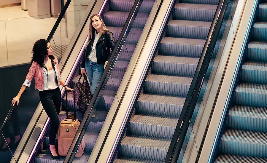 
Female passengers on TKE escalator
