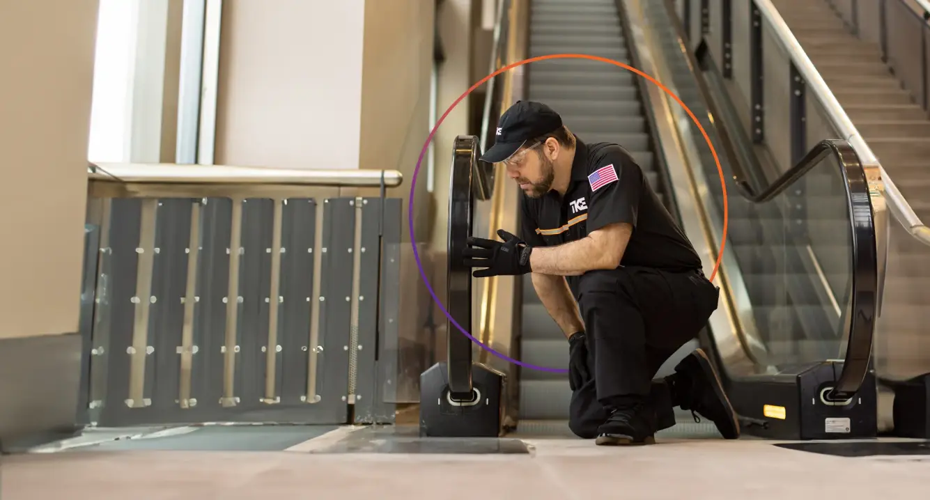 Technician performing maintenance services on an escalator to ensure safety and efficiency.