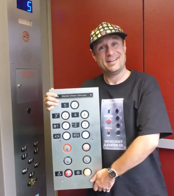 Andrew Reams holding a TK Elevator Control Panel