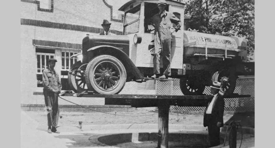 Peter Lunati observing an automobile lift in Memphis, 1926.