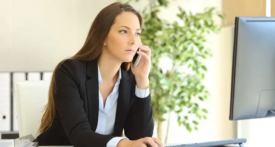 A woman in an office using a computer