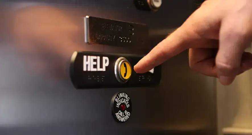 A standard elevator call button with a phone icon