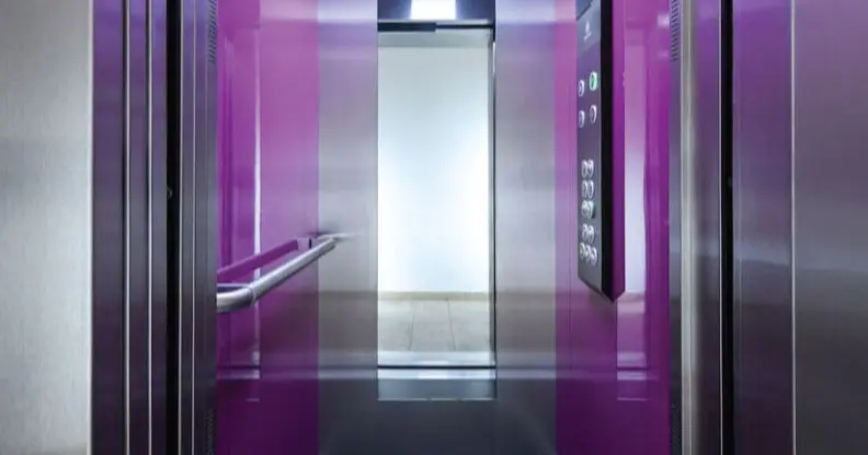 A purple elevator with its doors open