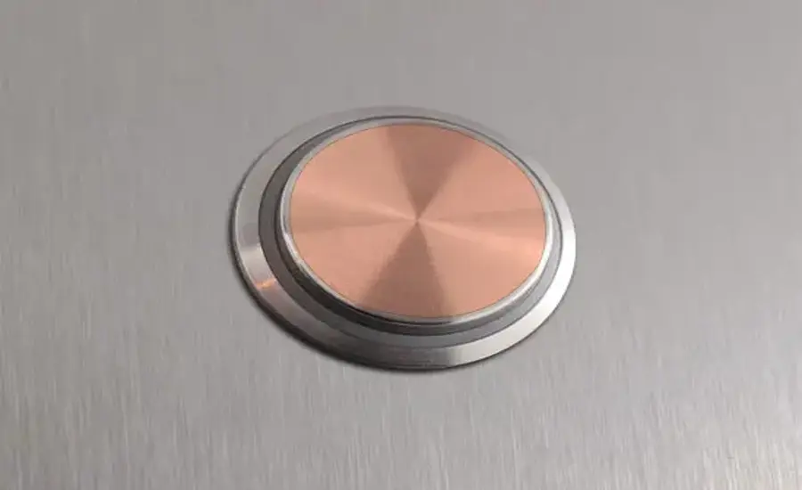 
A copper elevator call button.
