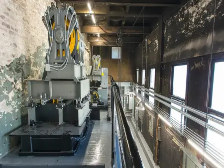 A view of a modernized machine room showing ageing walls with new equipment.