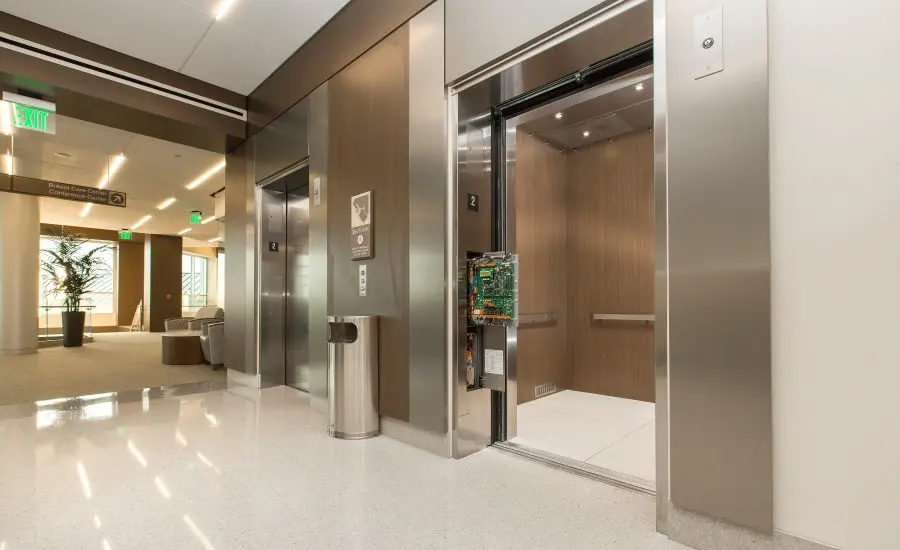 
An elevator standing open with the control panel exposed.
