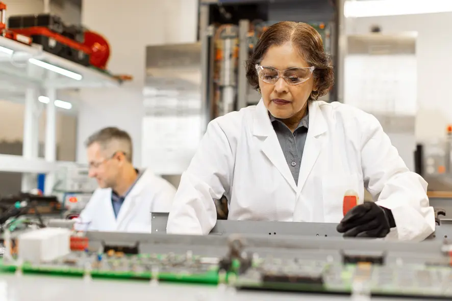 An engineer examining machinery in a lab.