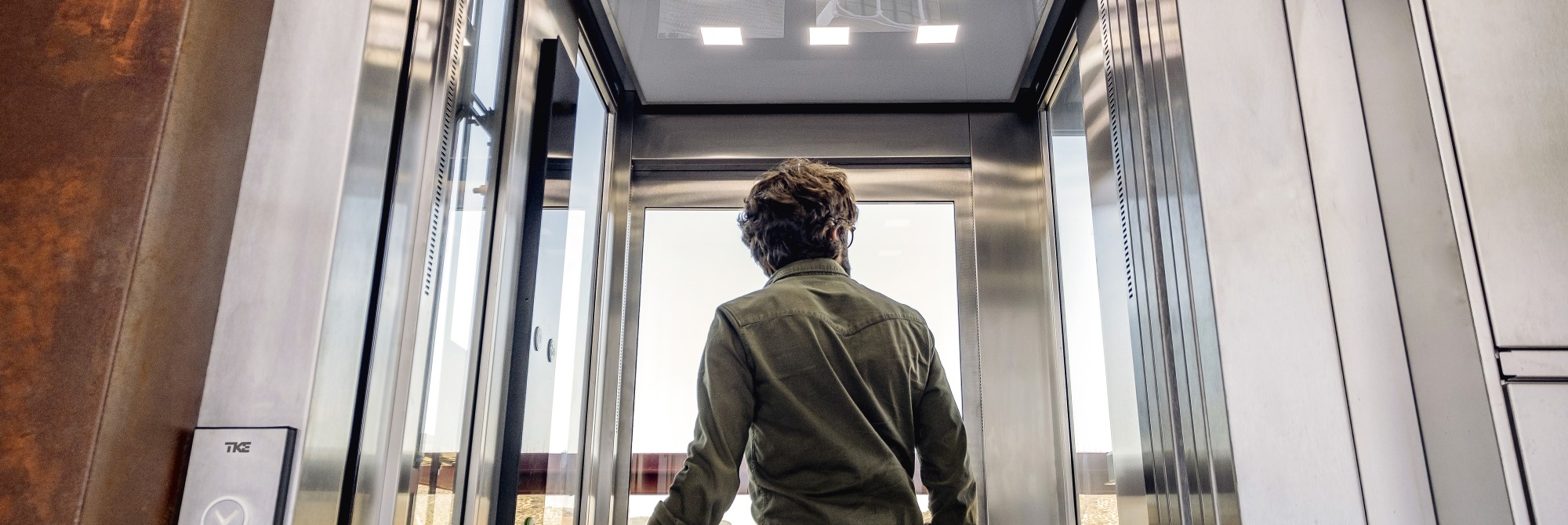 A passenger exiting a passenger elevator