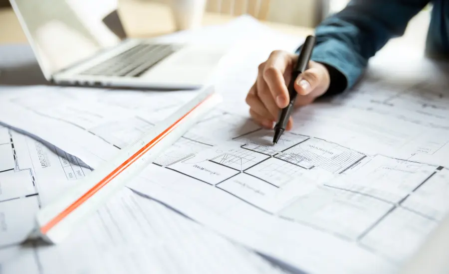 
An architect marks up a technical drawing.

